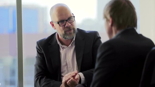 Boss is angry with his subordinate employee in the office and dismissal him