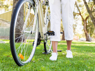 Naklejka premium Happy young woman with bicycle