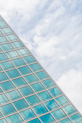 Building glass window pattern with a reflection of blue sky.