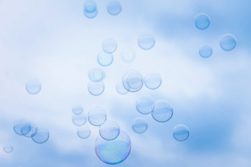 Rainbow Soap Bubbles on Blue Sky Background