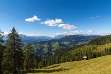 Small house in Alpine mountains in clear day