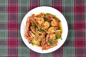 Stir-fried crab and shrimp in curry power is top-ten of popular Thai food as seafood to fried with  fresh milk ,grill curry ,egg ,oyster oil and yellow curry powder. 