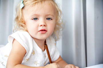 Little girl drawing at home