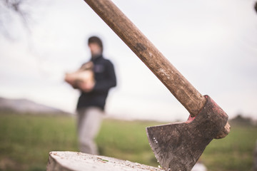 man chopping wood with an ax