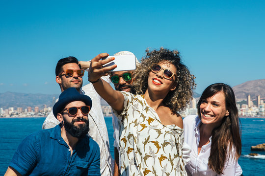 Positive friends makes selfie outdoors