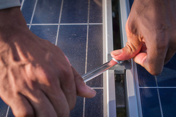 engineer working on  maintenance equipment at green energy solar power plant: working on Wrench tightening at solar mounting structure