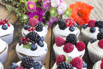 Cupcakes with Fruits on a Rustic Wooden Table