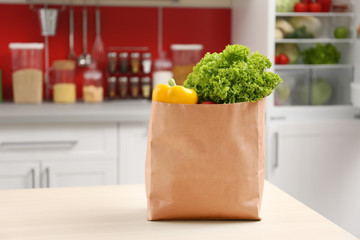 Bag with vegetables in kitchen