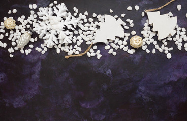 Christmas or New Year background: snowflakes, gifts, glass balls, decoration and cones on dark background