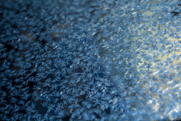 Close detail of ice flowers on a car windshield