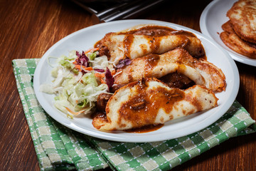 Potato pancakes with meat stew served