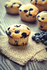 muffin with blueberries on a wooden table. fresh berries and swe
