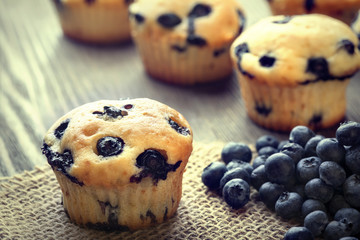 muffin with blueberries on a wooden table. fresh berries and swe