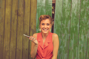 Obraz premium Beautiful woman using cellphone outdoors.
