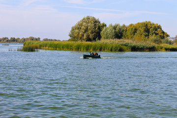 Fototapeta na wymiar Motorboat floating in the river Dnieper