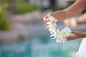 Foto op Aluminium Woman hands holding Flower lei garland of white plumeria. © abelena