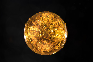 water with glass at black background