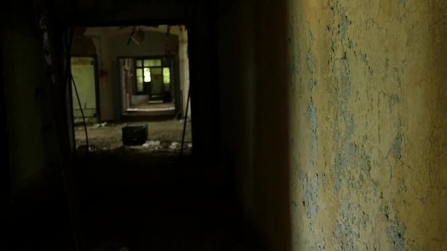 Creepy abandoned building, Spooky abandoned hallway steadicam shot, slow motion.