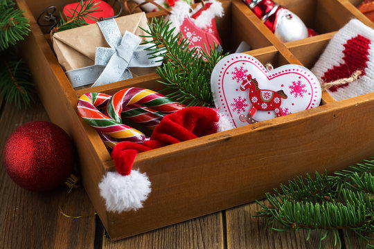 Wooden box with christmas decorationa, pines, candies