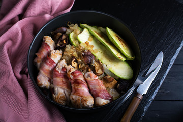 Grilled meat rolls wrapped in strips of bacon and marrow slices