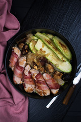 Grilled meat rolls wrapped in strips of bacon and marrow slices