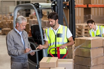 Warehouse manager and workers preparing a shipment 