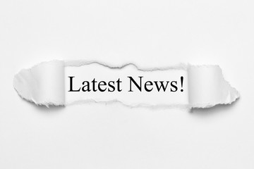 Latest News! on white torn paper