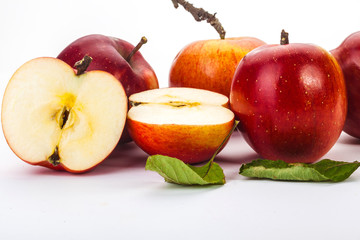 whole apples and half on a white background