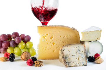 Cheese and wine with fruits and nuts.
