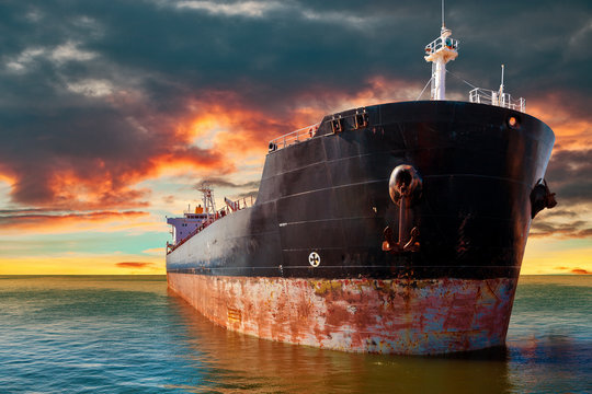 Big ship at sea on a background of sunset sky.