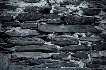 Detail of a wall of an ancient stone house. Toned
