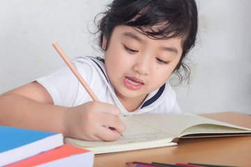 Beautiful little girl looking focused and concentrated on doing