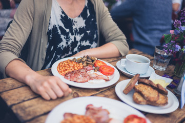 Young woman having an english breakfast