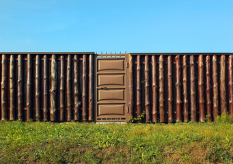 Wooden fence with metal gate door