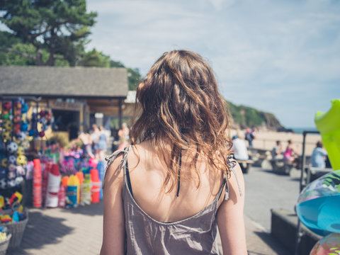 Young woman by shop on beach