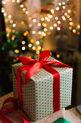 christmas gifts indoor on defocused lights background space for text