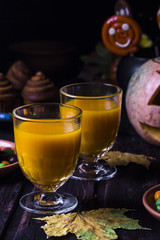 Halloween cocktail, pumpkin orange drink with spices
