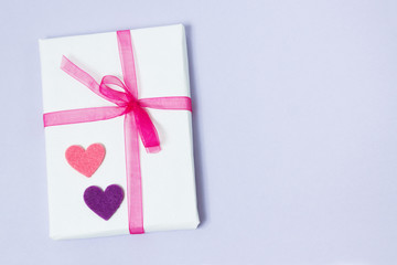 Packed gift with small heart on f violet background, not isolated. Top view, toned image, film effect