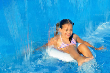 Real toddler girl relaxing at swimming pool
