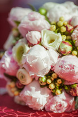 Light illuminates wedding bouquet made of tender peonies