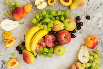 Fresh ripe fruits over stone table. Top view