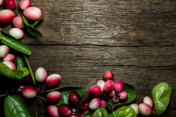 Carunda or Karonda on wood background