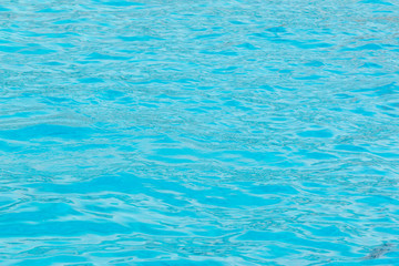 Blue swimming pool water surface texture.