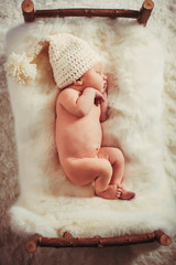 Incredible and sweet newborn baby sleeps on the bed