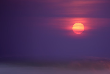 Foggy purple sunset or sunrise background