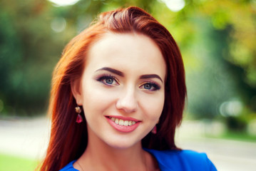 Naklejka premium Young beautiful woman portrait in the park