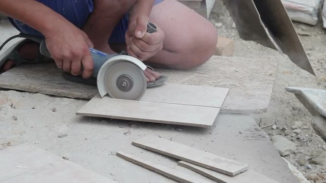Worker cutting tile saw blade