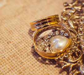 Golden rings lie on the steel mirror