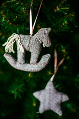 Cloth toy horse hangs on the Christmas tree