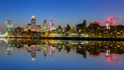 Cityscape of London with reflection in Thames river at night, UK